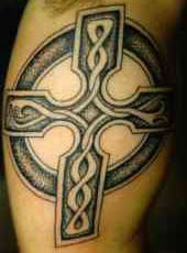 Long-drawn celtic cross tattoo